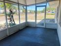 Enclosed porch with a view of the lawn and street at 3851 72Nd N St, St Petersburg, FL 33709