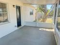 Enclosed porch with concrete floor and a glass-paned front door at 3851 72Nd N St, St Petersburg, FL 33709