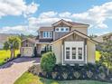 Beautiful exterior featuring a lush landscaped front yard and a brick driveway at 3952 Bonfire Dr, Odessa, FL 33556
