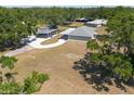 Drone shot of property, showcasing a long driveway, covered parking, and the house itself at 4416 Tevalo Dr, Valrico, FL 33596