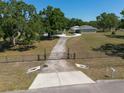 Aerial view of the property entrance, featuring a long driveway and gated entry at 4416 Tevalo Dr, Valrico, FL 33596