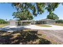 Property features a detached garage and carport, as well as a long driveway at 4416 Tevalo Dr, Valrico, FL 33596