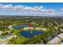 Aerial shot of waterfront townhomes with a community pool, tennis courts, and lake views at 4816 Snook Se Dr # F, St Petersburg, FL 33705