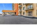 Exterior view showing covered parking with balconies and well-maintained landscaping at 4900 Brittany S Dr # 211, St Petersburg, FL 33715