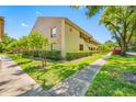 Condo building exterior with well-maintained landscaping and sidewalks, offering a serene environment at 4991 Puritan Cir # 522, Tampa, FL 33617