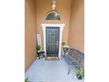 Welcoming front porch featuring a charming bench, decorative plants, and a 'Hello' doormat at 518 Greg St, Valrico, FL 33594