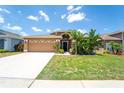 Beautiful single-Gathering home featuring well-kept lawn, mature landscaping, and a spacious driveway at 518 Greg St, Valrico, FL 33594