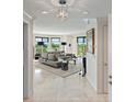 Bright living room features a neutral palette, tiled floor, and floor to ceiling windows at 555 5Th Ne Ave # 424, St Petersburg, FL 33701