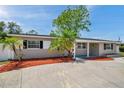 Inviting single-story home featuring beautiful landscaping, palm trees and a well-maintained front yard at 5660 Hobson Ne St, St Petersburg, FL 33703