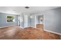 Spacious living room featuring terracotta floors and a view into the renovated kitchen at 5660 Hobson Ne St, St Petersburg, FL 33703