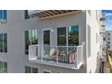 Cozy outdoor balcony space featuring chairs and a table, perfect for relaxing and enjoying the fresh air at 600 3Rd S Ave # 201, St Petersburg, FL 33701