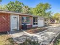 Inviting brick home with an attached garage, tidy front landscaping, and a welcoming entrance at 705 E Alabama St, Plant City, FL 33563