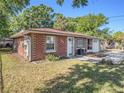 A well-maintained single story brick home with a tidy front yard and an attached garage at 705 E Alabama St, Plant City, FL 33563