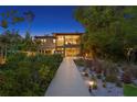 An exterior view of the backyard shows a long boardwalk leading to the house and tropical landscaping at 7508 N Ola Ave, Tampa, FL 33604