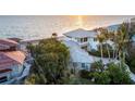 Beautiful beachfront home has metal roof with lush landscaping and breathtaking ocean views at 770 N Manasota Key Rd, Englewood, FL 34223