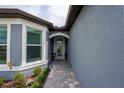 Inviting front entryway with a decorative glass door and a pathway of pavers at 9263 Barrier Coast Trl, Parrish, FL 34219