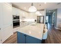 Modern kitchen featuring a spacious island with seating, stainless steel appliances, and sleek countertops at 9263 Barrier Coast Trl, Parrish, FL 34219