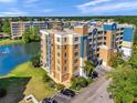 Condominium exterior, with stucco walls, balconies, mature landscaping and adjacent parking at 960 Starkey Rd # 1503, Largo, FL 33771
