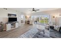 Bright living room with laminate floors, neutral walls, and balcony access overlooking the community at 960 Starkey Rd # 1503, Largo, FL 33771