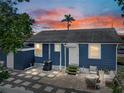 Backyard with a paved patio, outdoor seating, and a well-maintained exterior at 10562 Lake Dr, Seminole, FL 33772