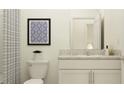 Cozy, clean bathroom featuring a toilet, shower with curtain, and stylish mirror/artwork combo at 10824 Keato Beach Ct, Tampa, FL 33647