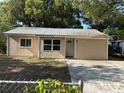 Charming single-story home with metal roof and ample front yard space at 1106 Woodlawn Ave, Plant City, FL 33563