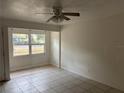 A modest Living Room with tiled floors and natural light streaming through the window at 1106 Woodlawn Ave, Plant City, FL 33563