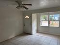 Bright living room featuring tiled floors, fan and a view from the front window at 1106 Woodlawn Ave, Plant City, FL 33563