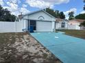Lovely single-story house with a neatly manicured front yard and bright blue driveway at 12447 Drysdale St, Spring Hill, FL 34609