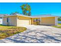Cozy home with an attached two-car garage, complemented by a well-maintained front lawn at 14136 Payne St, Spring Hill, FL 34609