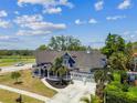 Aerial view of a stunning Victorian home with mature trees, large lot, and two-car garage at 1500 Elmwood St, Clearwater, FL 33755