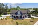 Lovely Victorian home with blue siding, white trim, inviting porch and two-car garage at 1500 Elmwood St, Clearwater, FL 33755