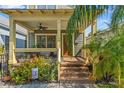 Inviting front porch with comfortable seating, decorative plants, and a stylish ceiling fan at 1816 E 15Th Ave, Tampa, FL 33605