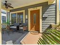 Cozy front porch with seating, a ceiling fan, and a beautifully crafted wooden front door at 1816 E 15Th Ave, Tampa, FL 33605