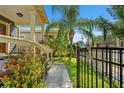 Well-maintained front yard with lush greenery, flowers, and a black metal fence at 1816 E 15Th Ave, Tampa, FL 33605