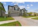 Charming two-story home boasts a stone facade, manicured lawn, and a spacious driveway at 19316 Eagle Creek Ln, Tampa, FL 33647