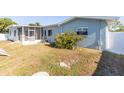 Large backyard featuring a screened-in patio, white fence, and room to roam at 22465 Lewiston Ave, Port Charlotte, FL 33952