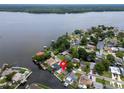 Aerial view of a waterfront property with lush landscaping and canal access to a wide, open lake at 250 W Canal Dr, Palm Harbor, FL 34684
