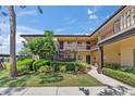 Attractive condo exterior featuring well-manicured greenery, neatly trimmed hedges, and inviting walkways at 2693 Sabal Springs Cir # 201, Clearwater, FL 33761