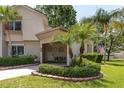 Inviting home exterior with manicured hedges, front patio, and American flag at 2722 Sand Hollow Ct # 2722, Clearwater, FL 33761