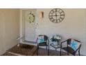 Charming front porch seating area with decorative wreath, starfish pillows, and heron at 2722 Sand Hollow Ct # 2722, Clearwater, FL 33761