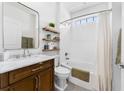 Bright bathroom features a single sink vanity, a shower over tub combo with white herringbone tile at 310 S Habana Ave # 5, Tampa, FL 33609