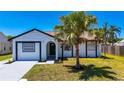 Inviting single-Gathering home with a well-maintained lawn and a mature palm tree at 3145 Munson St, New Port Richey, FL 34655
