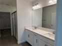 Bathroom with a double sink vanity, large mirror, and a glass-enclosed shower at 32024 Griffin Sands Ln, San Antonio, FL 33576