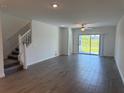Bright living room with tile floors, a ceiling fan, and sliding glass doors to the outside at 32024 Griffin Sands Ln, San Antonio, FL 33576