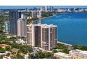 High rise building with a swimming pool surrounded by mature trees and a view of the city at 3301 Bayshore Blvd # 2207B, Tampa, FL 33629