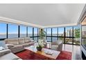 Bright living room with large windows, water view, hardwood floors and comfortable seating at 3301 Bayshore Blvd # 2207B, Tampa, FL 33629