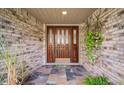 Inviting entryway with decorative tile and a stylish wooden front door at 3427 Forest Bridge Cir, Brandon, FL 33511