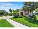 Beautifully landscaped front yard complements this lovely home with a brick-accented facade and a spacious driveway at 3610 Montero Ct, Sun City Center, FL 33573