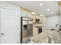 Modern kitchen featuring stainless steel appliances, granite countertops, and ample cabinet space at 36750 Us 19 N # 06111, Palm Harbor, FL 34684
